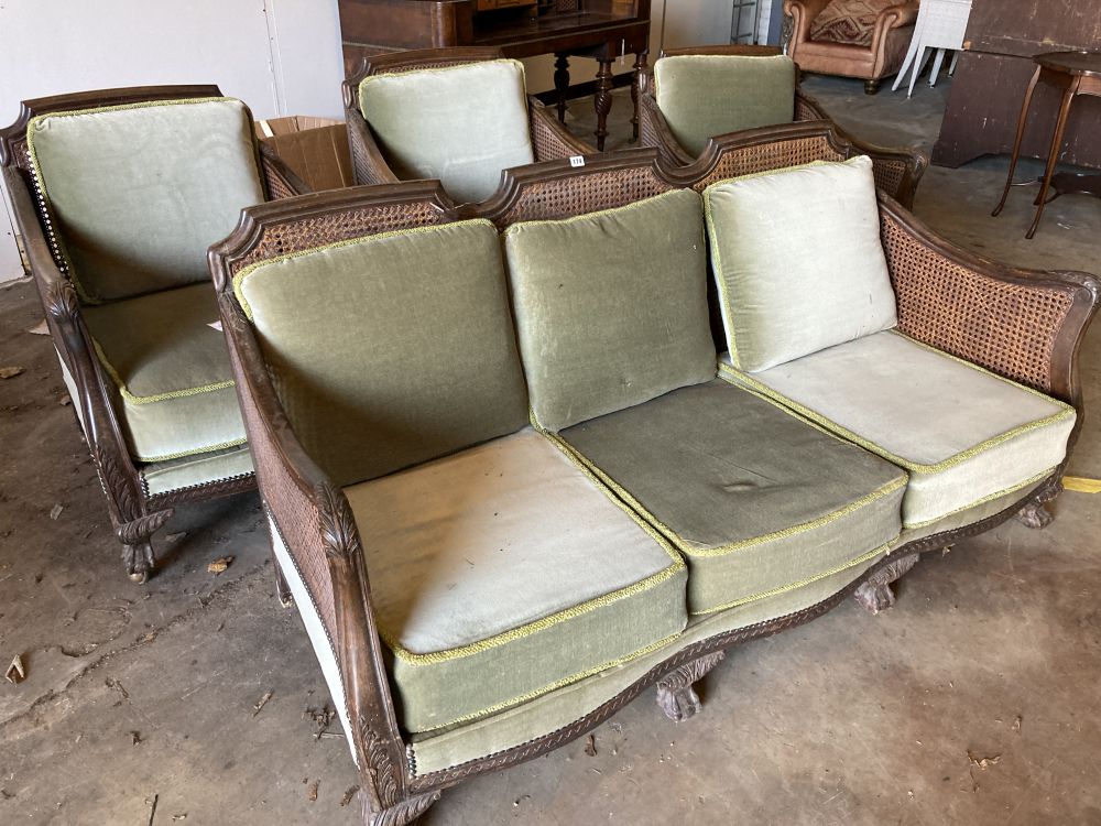 A 1920s carved beech four piece bergere suite